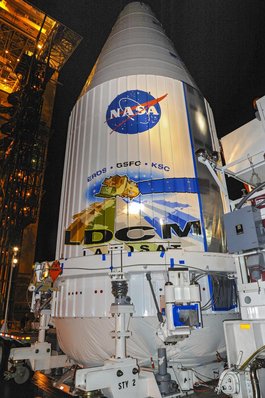 VANDENBERG AFB, Calif. -- The payload fairing containing the Landsat Data Continuity Mission, or LDCM, spacecraft arrives at Space Launch Complex-3E at Vandenberg Air Force Base, Calif. where it will be hoisted atop a United Launch Alliance Atlas V for launch.    The Landsat Data Continuity Mission LDCM is the future of Landsat satellites. It will continue to obtain valuable data and imagery to be used in agriculture, education, business, science, and government. The Landsat Program provides repetitive acquisition of high resolution multispectral data of the Earth's surface on a global basis. The data from the Landsat spacecraft constitute the longest record of the Earth's continental surfaces as seen from space. It is a record unmatched in quality, detail, coverage, and value. Liftoff is planned for Feb. 11, 2013 aboard a United Launch Alliance Atlas V rocket. For more information, visit: http:__www.nasa.gov_mission_pages_landsat_main_index.html Photo credit: NASA