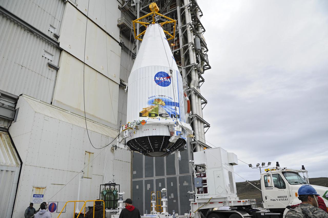 VANDENBERG AFB, Calif. -- The payload fairing containing the Landsat Data Continuity Mission, or LDCM, spacecraft is lifted to the top of Space Launch Complex-3E at Vandenberg Air Force Base, Calif. where it will be mounted atop a United Launch Alliance Atlas V rocket.    The Landsat Data Continuity Mission LDCM is the future of Landsat satellites. It will continue to obtain valuable data and imagery to be used in agriculture, education, business, science, and government. The Landsat Program provides repetitive acquisition of high resolution multispectral data of the Earth's surface on a global basis. The data from the Landsat spacecraft constitute the longest record of the Earth's continental surfaces as seen from space. It is a record unmatched in quality, detail, coverage, and value. Liftoff is planned for Feb. 11, 2013 aboard a United Launch Alliance Atlas V rocket. For more information, visit: http:__www.nasa.gov_mission_pages_landsat_main_index.html Photo credit: NASA