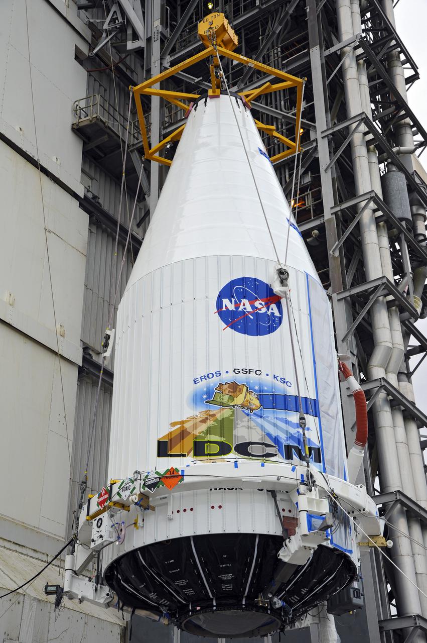 VANDENBERG AFB, Calif. -- The payload fairing containing the Landsat Data Continuity Mission, or LDCM, spacecraft is lifted to the top of Space Launch Complex-3E at Vandenberg Air Force Base, Calif. where it will be mounted atop a United Launch Alliance Atlas V rocket. The Landsat Data Continuity Mission LDCM is the future of Landsat satellites. It will continue to obtain valuable data and imagery to be used in agriculture, education, business, science, and government. The Landsat Program provides repetitive acquisition of high resolution multispectral data of the Earth's surface on a global basis. The data from the Landsat spacecraft constitute the longest record of the Earth's continental surfaces as seen from space. It is a record unmatched in quality, detail, coverage, and value. Liftoff is planned for Feb. 11, 2013 aboard a United Launch Alliance Atlas V rocket. For more information, visit: http:__www.nasa.gov_mission_pages_landsat_main_index.html Photo credit: NASA