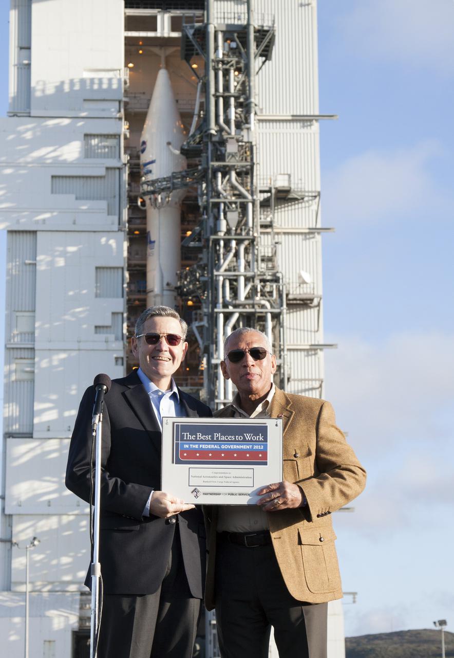VANDENBERG AFB, Calif. -- At Vandenberg Air Force Base, Calif., Kennedy Space Center Director Bob Cabana, left, and NASA Administrator Charles Bolden hold a plaque noting that the Partnership for Public Service has designated NASA first among large federal agencies at the best place to work in the federal government for 2012. In the background is Space Launch Complex 3E where an Atlas V rocket was poised for launch with the Landsat Data Continuity Mission satellite. The Landsat Data Continuity Mission LDCM is the future of Landsat satellites. It will continue to obtain valuable data and imagery to be used in agriculture, education, business, science, and government. The Landsat Program provides repetitive acquisition of high resolution multispectral data of the Earth's surface on a global basis. The data from the Landsat spacecraft constitute the longest record of the Earth's continental surfaces as seen from space. It is a record unmatched in quality, detail, coverage, and value. Liftoff is planned for Feb. 11, 2013 aboard a United Launch Alliance Atlas V rocket. For more information, visit: http:__www.nasa.gov_mission_pages_landsat_main_index.html Photo credit: NASA_Kim Shiflett