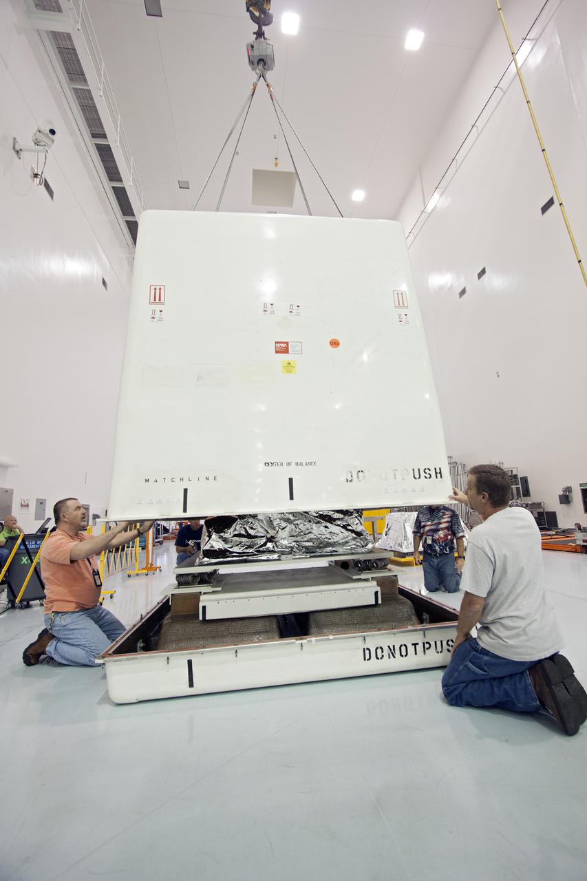 CAPE CANAVERAL, Fla. -- Inside the Space Station Processing Facility at NASA's Kennedy Space Center in Florida, technicians finish lowering the cover of a shipping container that will enclose the orbital replacement unit for the space station's utility transfer assembly.  The unit is one of the payloads processed at Kennedy that will be flown to Japan for the HTV-4 launch to the station, which is currently scheduled for this summer. Photo credit: NASA_Jim Grossmann