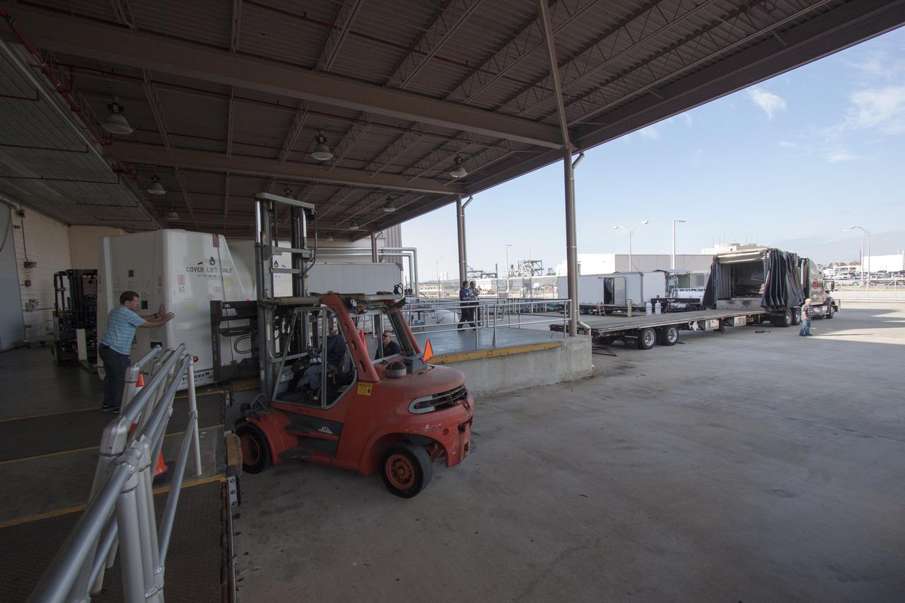 CAPE CANAVERAL, Fla. -- Workers prepare to load the payload shipping containers that hold the unpressurized Orbital Replacement Units ORU for the International Space Station's Main Bus Switching Unit MBSU and Utility Transfer Assembly UTA, as well as the Space Test Program-Houston 4 STP H-4 experiments, on a transport. The payloads were processed at Kennedy and will be trucked to Chicago. From Chicago, they will be moved by air freight to Narita, Japan, where a complicated combination of ground and ocean ferry transfers will be used to deliver them to the Tanegashima Space Center. At Tanegashima the payloads will be turned over to the Japan Aerospace Exploration Agency JAXA in preparation for launch on the H-II Transfer Vehicle 4 HTV-4 mission this summer. Photo credit: NASA_Jim Grossmann