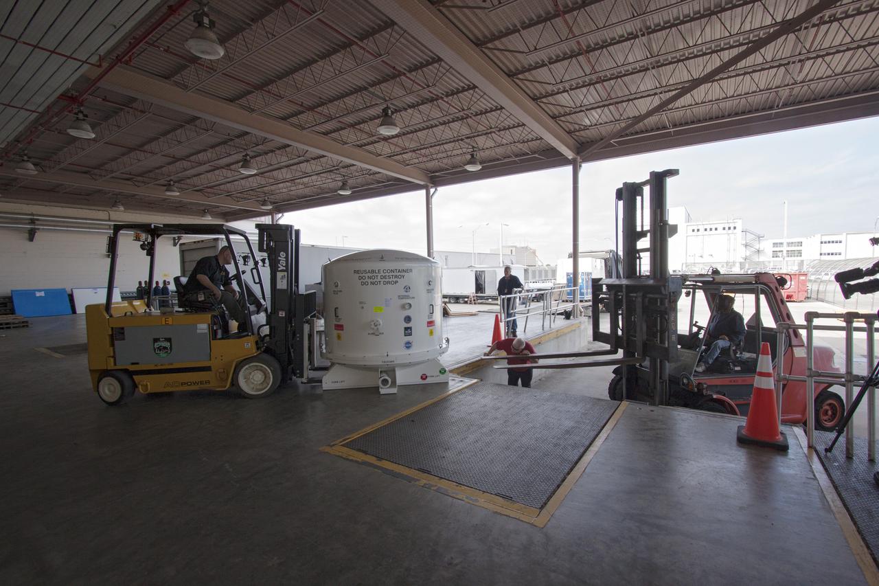 CAPE CANAVERAL, Fla. -- Workers prepare to load the payload shipping container that holds the Space Test Program-Houston 4 STP H-4 experiments on a transport that will also carry containers with the unpressurized Orbital Replacement Units ORU for the International Space Station's Main Bus Switching Unit MBSU and Utility Transfer Assembly UTA. The payloads were processed at Kennedy and will be trucked to Chicago. From Chicago, they will be moved by air freight to Narita, Japan, where a complicated combination of ground and ocean ferry transfers will be used to deliver them to the Tanegashima Space Center. At Tanegashima the payloads will be turned over to the Japan Aerospace Exploration Agency JAXA in preparation for launch on the H-II Transfer Vehicle 4 HTV-4 mission this summer. Photo credit: NASA_Jim Grossmann