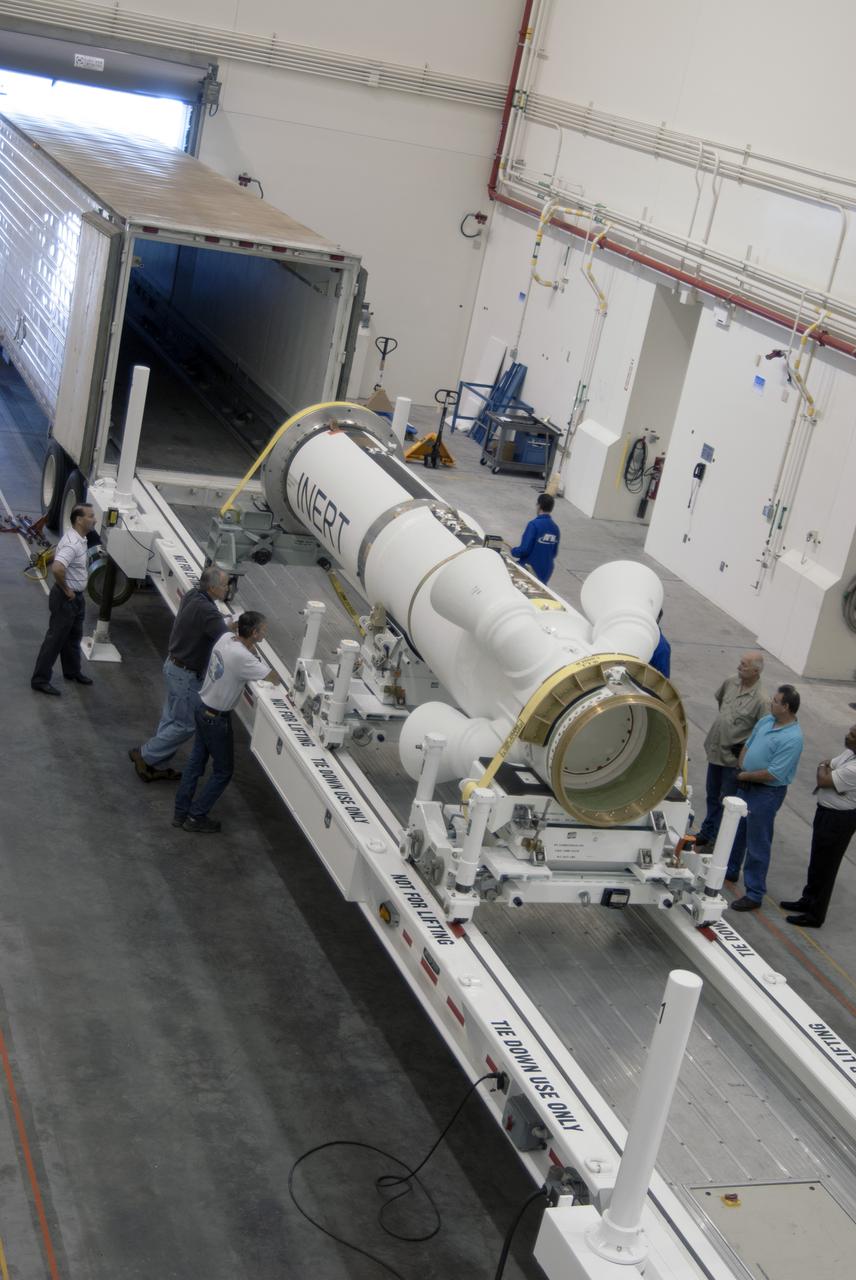 CAPE CANAVERAL, Fla. – Inside the Launch Abort System Facility at NASA’s Kennedy Space Center in Florida, technicians have removed the Alliant Techsystems, or ATK, launch abort motor from a truck. The test flight launch abort motor is for Exploration Flight Test 1, or EFT-1, of the agency’s Orion Multi-Purpose Crew Vehicle. It is part of Orion’s Launch Abort System, which is designed to safely pull the Orion crew module away from the launch vehicle in the event of an emergency on the launch pad or during the initial ascent of NASA’s Space Launch System, or SLS, rocket. The motor is configured with inert propellant.  Orion is the exploration spacecraft designed to carry crews to space beyond low Earth orbit. It will provide emergency abort capability, sustain the crew during the space travel and provide safe re-entry from deep space return velocities. Orion’s first unpiloted test flight is scheduled to launch in 2014 atop a Delta IV rocket. A second uncrewed flight test is scheduled for 2017 on the SLS rocket. For more information, visit http:__www.nasa.gov_orion. Photo credit: NASA_Charisse Nahser