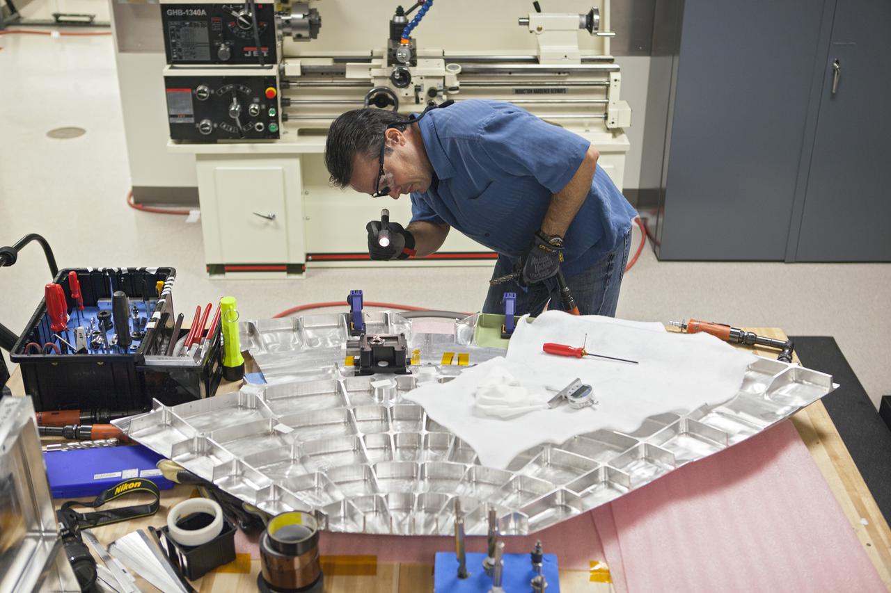 CAPE CANAVERAL, Fla. -- Inside the Operations and Checkout Building high bay at NASA’s Kennedy Space Center in Florida, a technician practices a procedure to repair cracks on the agency’s Orion Exploration Flight Test 1 crew module, during a dry run. During proof pressure testing on the vehicle, the spacecraft sustained three cracks in the aft bulkhead. A team composed of Lockheed Martin and NASA engineers designed a set of brackets that will be used to repair the area, as well as tooling to fix the cracked structure. Orion is the exploration spacecraft designed to carry humans further into space than ever before. It will provide emergency abort capability, sustain the crew during the space travel and provide safe re-entry from deep space return velocities. Orion’s first unpiloted test flight is scheduled to launch in 2014 atop a United Launch Alliance Delta IV heavy rocket. A second uncrewed flight test is scheduled for 2017 on the Space Launch System rocket. For more information, visit http:__www.nasa.gov_orion. Photo credit: NASA_Dimitri Gerondidakis