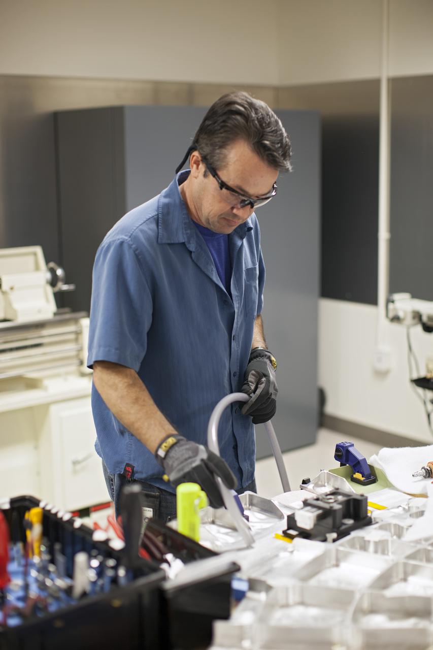 CAPE CANAVERAL, Fla. -- Inside the Operations and Checkout Building high bay at NASA’s Kennedy Space Center in Florida, a technician practices a procedure to repair cracks on the agency’s Orion Exploration Flight Test 1 crew module, during a dry run. During proof pressure testing on the vehicle, the spacecraft sustained three cracks in the aft bulkhead. A team composed of Lockheed Martin and NASA engineers designed a set of brackets that will be used to repair the area, as well as tooling to fix the cracked structure. Orion is the exploration spacecraft designed to carry humans further into space than ever before. It will provide emergency abort capability, sustain the crew during the space travel and provide safe re-entry from deep space return velocities. Orion’s first unpiloted test flight is scheduled to launch in 2014 atop a United Launch Alliance Delta IV heavy rocket. A second uncrewed flight test is scheduled for 2017 on the Space Launch System rocket. For more information, visit http:__www.nasa.gov_orion. Photo credit: NASA_Dimitri Gerondidakis