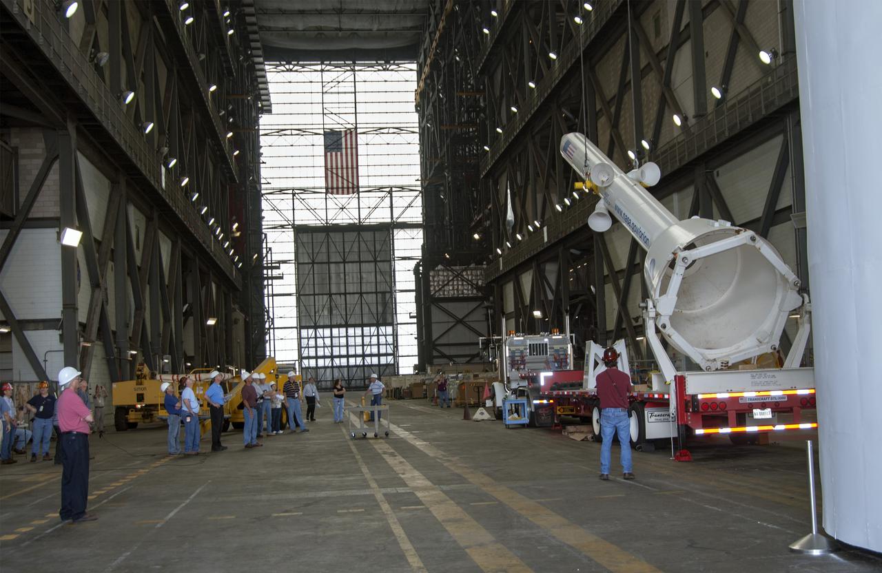 CAPE CANAVERAL, Fla. – A mockup of the Launch Abort System, or LAS, is lifted off a trailer inside the Vehicle Assembly Building at NASA's Kennedy Space Center in Florida so it can be positioned atop a boilerplate Orion capsule during test stacking operations. The Orion spacecraft is being designed to carry astronauts on missions beyond Earth orbit. It will have the LAS during the first part of launch in case an emergency develops that requires the spacecraft to be pulled away from the rocket to save the crew. NASA's Ground Services Development and Operations Program, or GSDO, performed the test operations. Photo credit: NASA_Charisse Nahser