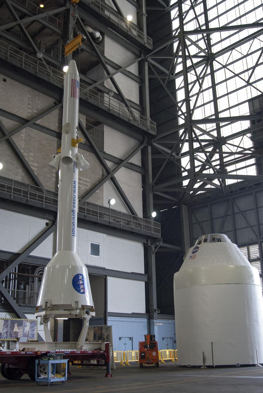CAPE CANAVERAL, Fla. – A mockup of the Launch Abort System, or LAS, is lifted off a trailer inside the Vehicle Assembly Building at NASA's Kennedy Space Center in Florida so it can be positioned atop a boilerplate Orion capsule and replica service module during test stacking operations. The Orion spacecraft is being designed to carry astronauts on missions beyond Earth orbit. It will have the LAS during the first part of launch in case an emergency develops that requires the spacecraft to be pulled away from the rocket to save the crew. NASA's Ground Services Development and Operations Program, or GSDO, performed the test operations. Photo credit: NASA_Charisse Nahser