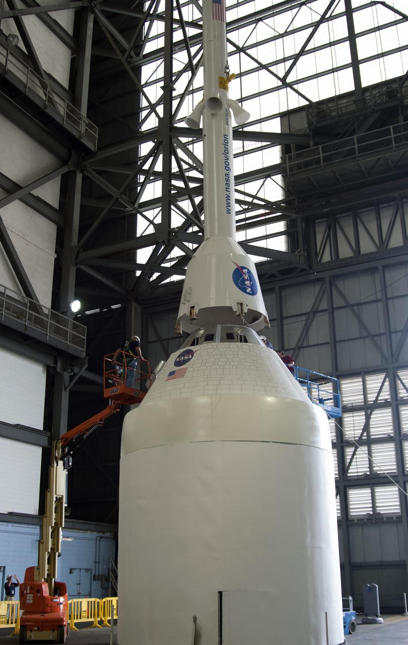 CAPE CANAVERAL, Fla. – A mockup of the Launch Abort System, or LAS, is positioned atop a boilerplate Orion capsule and replica service module during test stacking operations inside the Vehicle Assembly Building at NASA's Kennedy Space Center in Florida. The Orion spacecraft is being designed to carry astronauts on missions beyond Earth orbit. It will have the LAS during the first part of launch in case an emergency develops that requires the spacecraft to be pulled away from the rocket to save the crew. NASA's Ground Services Development and Operations Program, or GSDO, performed the test operations. Photo credit: NASA_Charisse Nahser