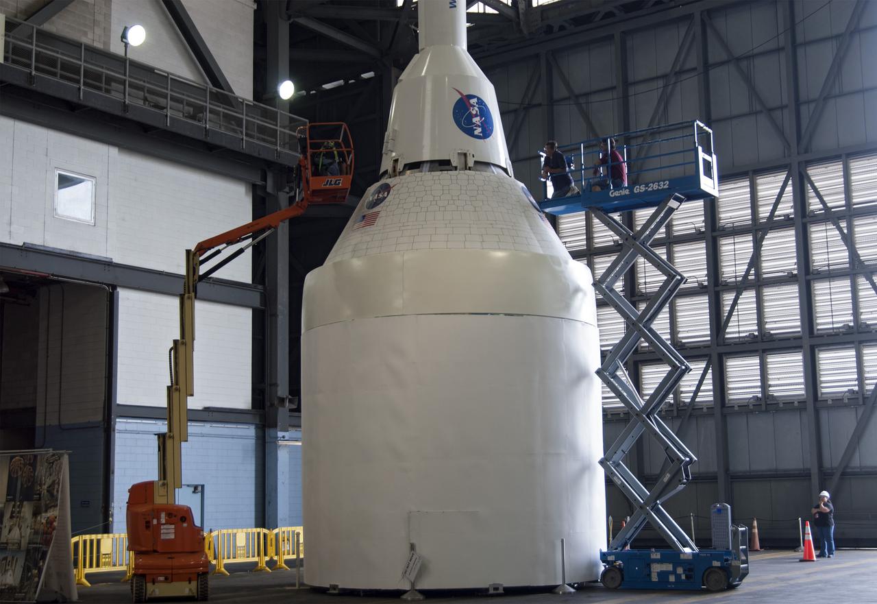 CAPE CANAVERAL, Fla. – A mockup of the Launch Abort System, or LAS, is positioned atop a boilerplate Orion capsule and replica service module during test stacking operations inside the Vehicle Assembly Building at NASA's Kennedy Space Center in Florida. The Orion spacecraft is being designed to carry astronauts on missions beyond Earth orbit. It will have the LAS during the first part of launch in case an emergency develops that requires the spacecraft to be pulled away from the rocket to save the crew. NASA's Ground Services Development and Operations Program, or GSDO, performed the test operations. Photo credit: NASA_Charisse Nahser