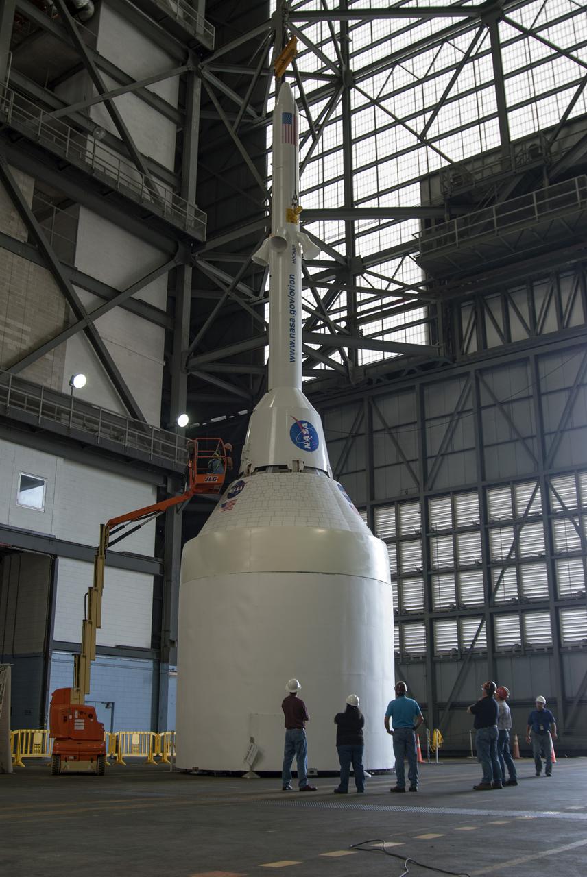 CAPE CANAVERAL, Fla. – A mockup of the Launch Abort System, or LAS, is positioned atop a boilerplate Orion capsule and replica service module during test stacking operations inside the Vehicle Assembly Building at NASA's Kennedy Space Center in Florida. The Orion spacecraft is being designed to carry astronauts on missions beyond Earth orbit. It will have the LAS during the first part of launch in case an emergency develops that requires the spacecraft to be pulled away from the rocket to save the crew. NASA's Ground Services Development and Operations Program, or GSDO, performed the test operations. Photo credit: NASA_Charisse Nahser