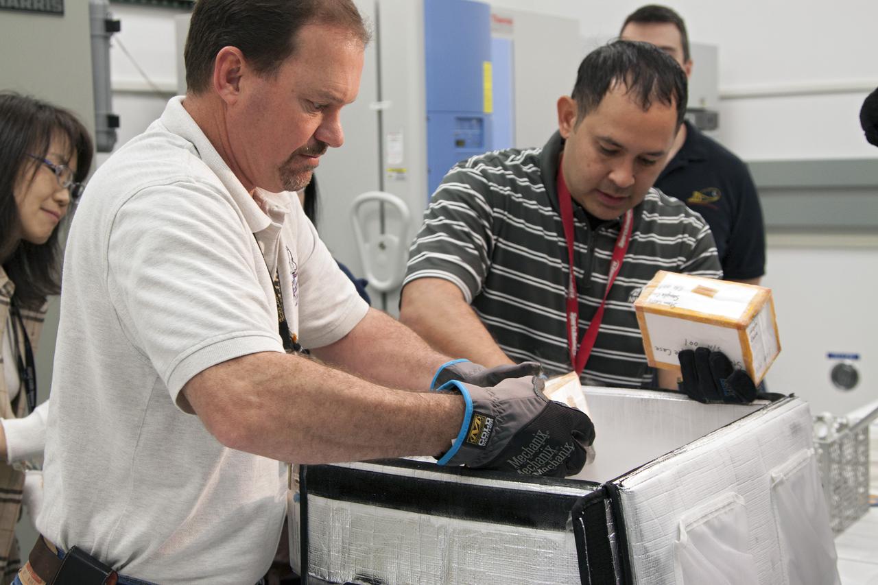 CAPE CANAVERAL, Fla. - In the Space Station Processing Facility at NASA's Kennedy Space Center in Florida, engineers prepare to load experiments requiring low temperatures into the General Laboratory Active Cryogenic International Space Station ISS Experiment Refrigerator, or GLACIER. The samples will then be transported to Space Launch Complex-40 on Cape Canaveral Air Force Station where the GLACIER will be loaded aboard the SpaceX Dragon capsule.  Scheduled for launch on March 1 atop a Falcon 9 rocket, Dragon will be marking its third trip to the space station. The mission is the second of 12 SpaceX flights contracted by NASA to resupply the orbiting laboratory. For more information, visit http:__www.nasa.gov_mission_pages_station_structure_launch_spacex2-feature.html Photo credit: NASA_Kim Shiflett