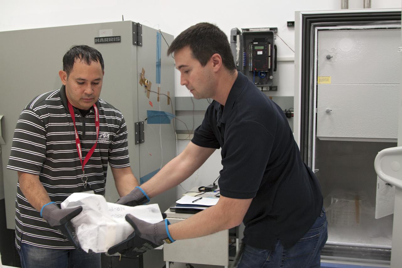 CAPE CANAVERAL, Fla. - In the Space Station Processing Facility at NASA's Kennedy Space Center in Florida, engineers prepare to load experiments requiring low temperatures into the General Laboratory Active Cryogenic International Space Station ISS Experiment Refrigerator, or GLACIER. The samples will then be transported to Space Launch Complex-40 on Cape Canaveral Air Force Station where the GLACIER will be loaded aboard the SpaceX Dragon capsule.  Scheduled for launch on March 1 atop a Falcon 9 rocket, Dragon will be marking its third trip to the space station. The mission is the second of 12 SpaceX flights contracted by NASA to resupply the orbiting laboratory. For more information, visit http:__www.nasa.gov_mission_pages_station_structure_launch_spacex2-feature.html Photo credit: NASA_Kim Shiflett