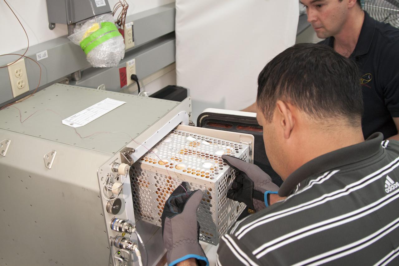CAPE CANAVERAL, Fla. - In the Space Station Processing Facility at NASA's Kennedy Space Center in Florida, engineers load experiments requiring low temperatures into the General Laboratory Active Cryogenic International Space Station ISS Experiment Refrigerator, or GLACIER. The samples will then be transported to Space Launch Complex-40 on Cape Canaveral Air Force Station where the GLACIER will be loaded aboard the SpaceX Dragon capsule.   Scheduled for launch on March 1 atop a Falcon 9 rocket, Dragon will be marking its third trip to the space station. The mission is the second of 12 SpaceX flights contracted by NASA to resupply the orbiting laboratory. For more information, visit http:__www.nasa.gov_mission_pages_station_structure_launch_spacex2-feature.html Photo credit: NASA_Kim Shiflett