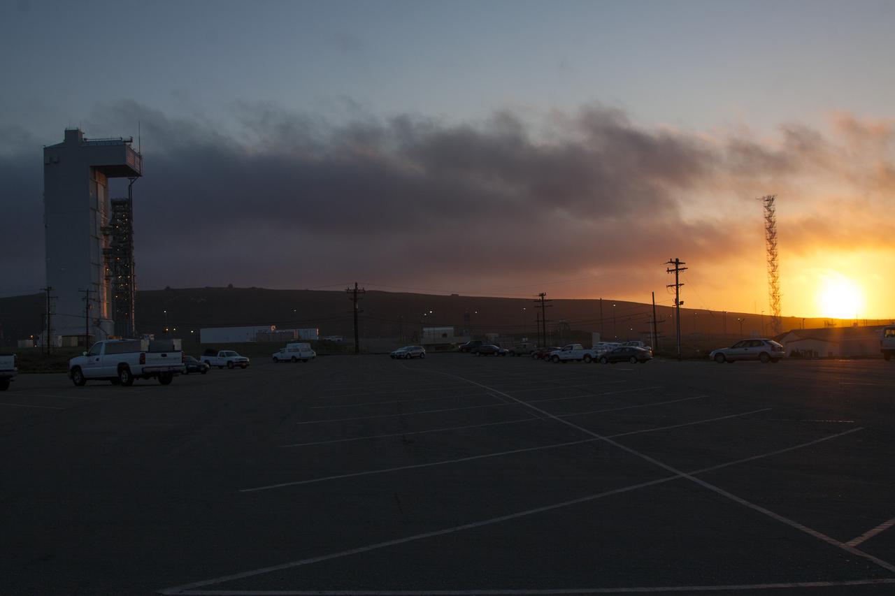 VANDENBERG AFB, Calif. -- The sun sets in the west behind Space Launch Complex 3 at Vandenberg Air Force Base where preparations continue for the launch of the Landsat Data Continuity Mission, or LDCM, satellite atop an Atlas V rocket. The Landsat Data Continuity Mission LDCM is the future of Landsat satellites. It will continue to obtain valuable data and imagery to be used in agriculture, education, business, science, and government. The Landsat Program provides repetitive acquisition of high resolution multispectral data of the Earth's surface on a global basis. The data from the Landsat spacecraft constitute the longest record of the Earth's continental surfaces as seen from space. It is a record unmatched in quality, detail, coverage, and value. Liftoff is planned for Feb. 11, 2013 aboard a United Launch Alliance Atlas V rocket. For more information, visit: http:__www.nasa.gov_mission_pages_landsat_main_index.html Photo credit: NASA_ Ben Smegelsky