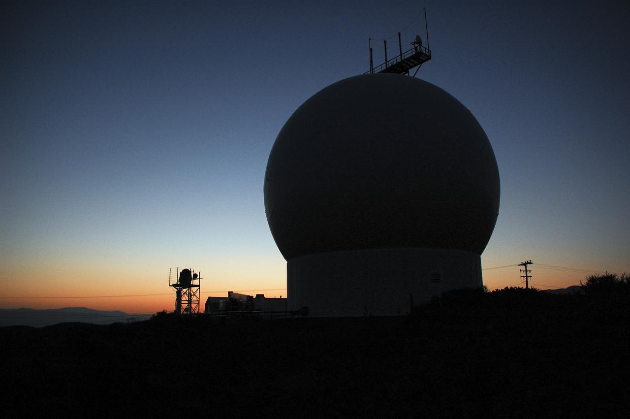 VANDENBERG AFB, Calif. – Tracking equipment and antennas show in silhouette as the sun rises over a United Launch Alliance Atlas V rocket carrying the Landsat Data Continuity Mission spacecraft from Vandenberg Air Force Base in California. Photo credit: NASA_Ben Smegelsky