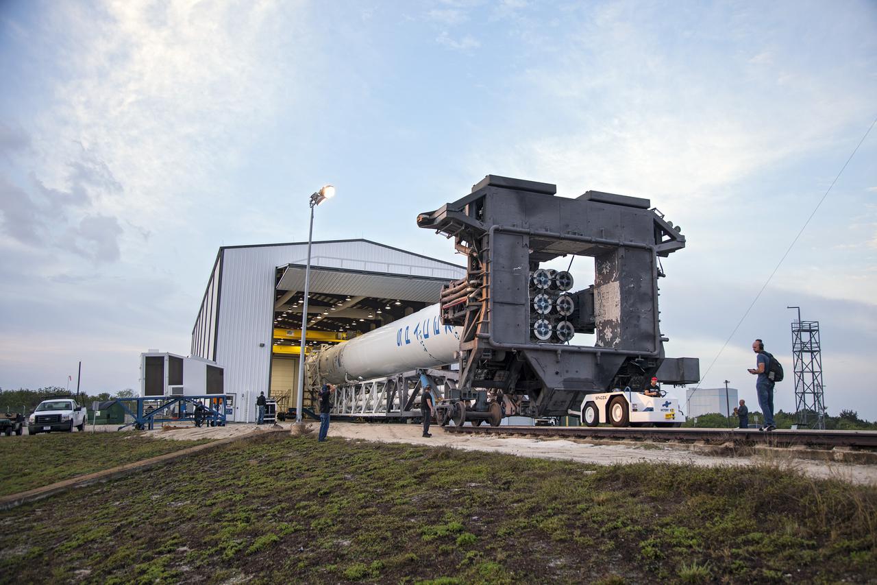 CAPE CANAVERAL, Fla. - The SpaceX Falcon 9 rocket moves out of the company's Falcon Hangar at Launch Complex 40 on Cape Canaveral Air Force Station in Florida. The rocket is rolling to the launch pad for a test firing of its nine Merlin first-stage engines in preparation for the SpaceX 2 launch.  Liftoff of the SpaceX Falcon 9 rocket and Dragon spacecraft is planned for March 1, 2013, at 10:10 a.m. EST, from Space Launch Complex-40 at Cape Canaveral Air Force Station, Fla. Dragon will be making its third trip to the space station. It will carry supplies and experiments to the orbiting laboratory. The mission is the second of 12 SpaceX flights contracted by NASA to resupply the space station. For more information, visit http:__www.nasa.gov_mission_pages_station_structure_launch_spacex2-feature.html Photo credit: NASA_Frankie Martin