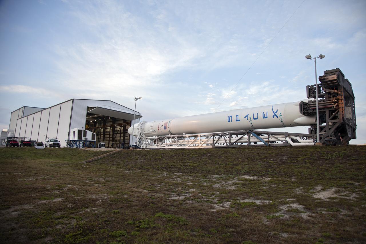 CAPE CANAVERAL, Fla. - The SpaceX Falcon 9 rocket moves away from the company's Falcon Hangar at Launch Complex 40 on Cape Canaveral Air Force Station in Florida. The rocket is rolling to the launch pad for a test firing of its nine Merlin first-stage engines in preparation for the SpaceX 2 launch.  Liftoff of the SpaceX Falcon 9 rocket and Dragon spacecraft is planned for March 1, 2013, at 10:10 a.m. EST, from Space Launch Complex-40 at Cape Canaveral Air Force Station, Fla. Dragon will be making its third trip to the space station. It will carry supplies and experiments to the orbiting laboratory. The mission is the second of 12 SpaceX flights contracted by NASA to resupply the space station. For more information, visit http:__www.nasa.gov_mission_pages_station_structure_launch_spacex2-feature.html Photo credit: NASA_Frankie Martin