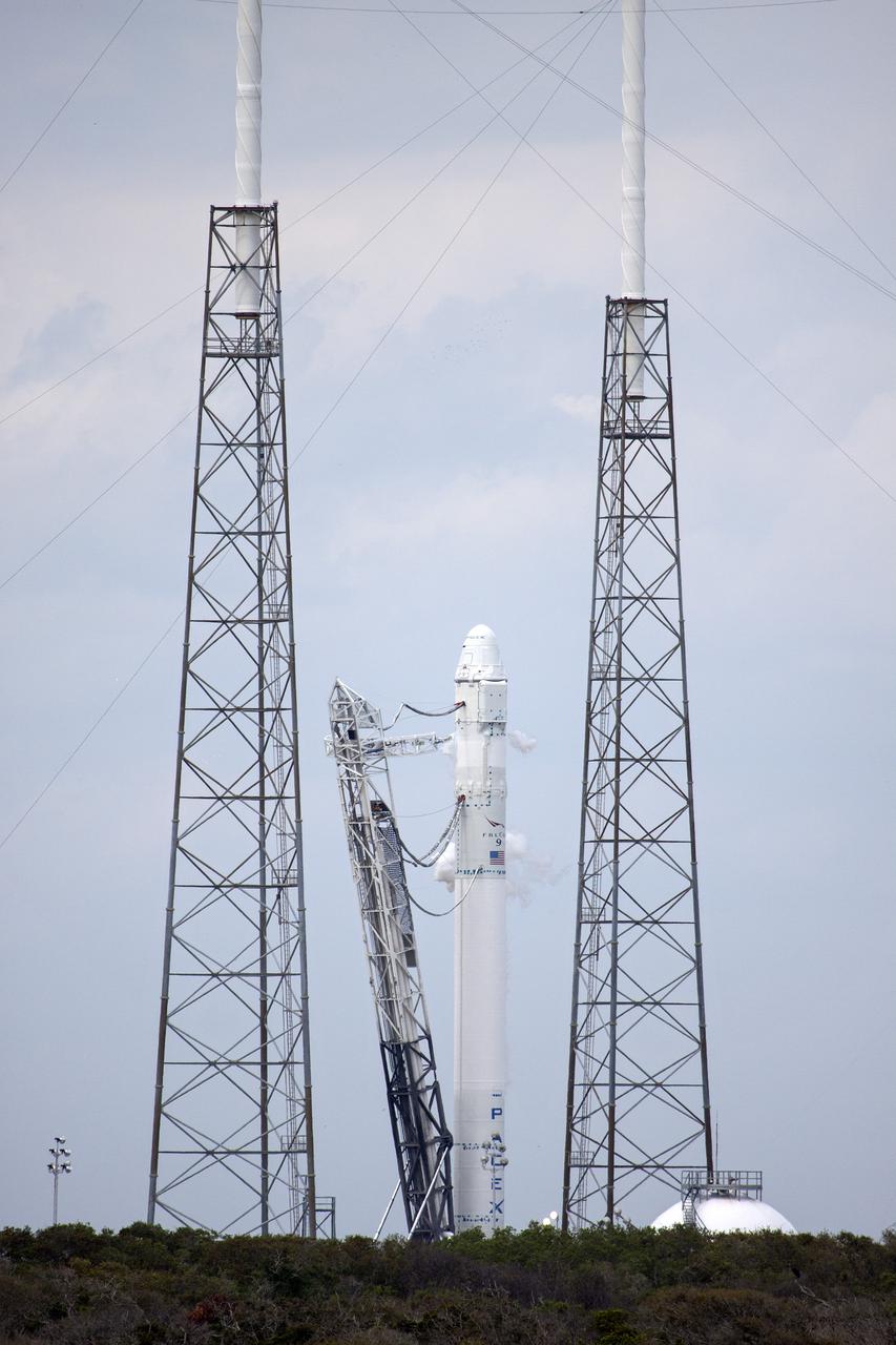 CAPE CANAVERAL, Fla. - The gantry-like strongback structure at Launch Complex 40 has been lowered prior to a test firing of the SpaceX Falcon 9 rocket's nine Merlin first-stage engines. The test is part of SpaceX 2 prelaunch preparations at Cape Canaveral Air Force Station in Florida.  Liftoff of the SpaceX Falcon 9 rocket and Dragon spacecraft is planned for March 1, 2013, at 10:10 a.m. EST, from Space Launch Complex-40 at Cape Canaveral Air Force Station, Fla. Dragon will be making its third trip to the space station. It will carry supplies and experiments to the orbiting laboratory. The mission is the second of 12 SpaceX flights contracted by NASA to resupply the space station. For more information, visit http:__www.nasa.gov_mission_pages_station_structure_launch_spacex2-feature.html Photo credit: NASA_Jim Grossmann