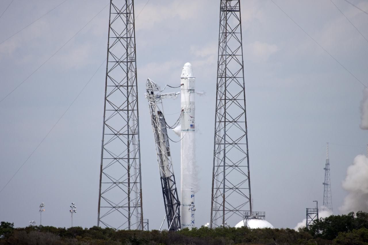 CAPE CANAVERAL, Fla. - Smoke billows from the SpaceX Falcon 9 rocket's nine first-stage Merlin engines during a test firing at Launch Complex 40 at Cape Canaveral Air Force Station in Florida. The test is part of SpaceX 2 prelaunch preparations.   Liftoff of the SpaceX Falcon 9 rocket and Dragon spacecraft is planned for March 1, 2013, at 10:10 a.m. EST, from Space Launch Complex-40 at Cape Canaveral Air Force Station, Fla. Dragon will be making its third trip to the space station. It will carry supplies and experiments to the orbiting laboratory. The mission is the second of 12 SpaceX flights contracted by NASA to resupply the space station. For more information, visit http:__www.nasa.gov_mission_pages_station_structure_launch_spacex2-feature.html Photo credit: NASA_Jim Grossmann