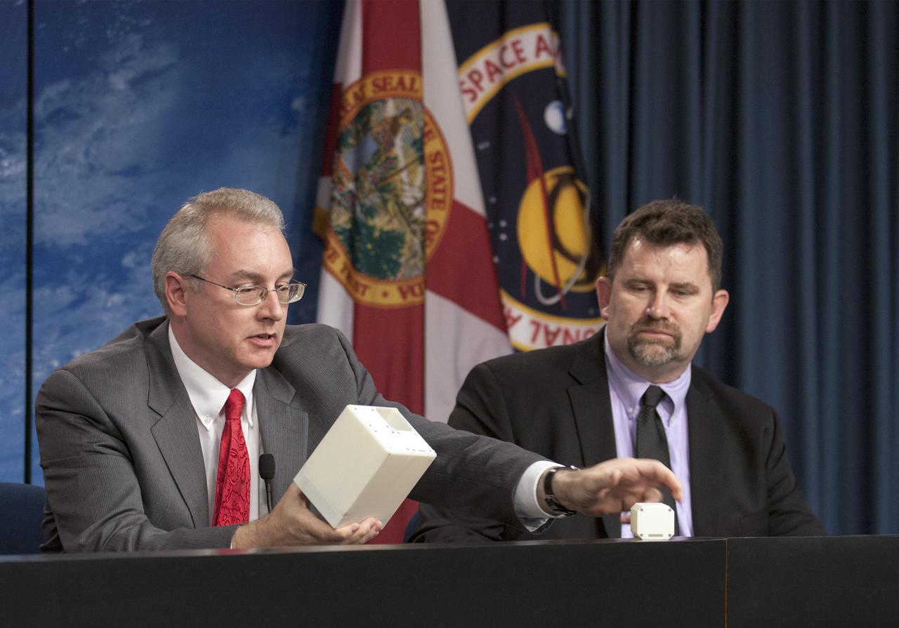CAPE CANAVERAL, Fla. - Media attending a pre-launch news conference at the Kennedy Space Center, Fla. heard from Michael Johnson, chief technical officer for NanoRacks, who described experiments to be transported to the International Space Station on the SpaceX 2 mission. Looking on from the right is Michael Roberts, research scientist with the Center for Advancement of Science in Space.   Scheduled for launch March 1 atop a Falcon 9 rocket, the SpaceX Dragon capsule will be making its third trip to the space station. The mission is the second of 12 SpaceX flights contracted by NASA to resupply the orbiting laboratory. For more information, visit http:__www.nasa.gov_mission_pages_station_structure_launch_spacex2-feature.html Photo credit: NASA_Kim Shiflett