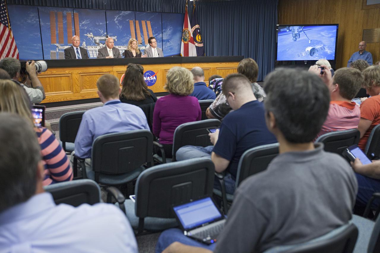 CAPE CANAVERAL, Fla. - Media attending a pre-launch news conference at the Kennedy Space Center, Fla. heard from officials who discussed payloads to be launched aboard a SpaceX Dragon capsule. From the left are: Mike Curie of NASA Public Affairs at the Kennedy Space Center, Mike Suffredini, NASA program manager for the International Space Station at the Johnson Space Center, Gwynne Shotwell, president of SpaceX, and Joel Tumbiolo, launch weather officer for the 45th Weather Squadron at Cape Canaveral Air Force Station. Scheduled for launch March 1 atop a Falcon 9 rocket, the SpaceX Dragon capsule will be making its third trip to the space station. The mission is the second of 12 SpaceX flights contracted by NASA to resupply the orbiting laboratory. For more information, visit http:__www.nasa.gov_mission_pages_station_structure_launch_spacex2-feature.html Photo credit: NASA_Kim Shiflett