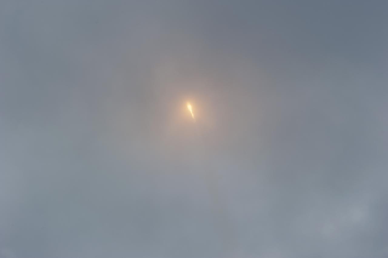 CAPE CANAVERAL, Fla. -- A Space Exploration Technologies, or SpaceX, Falcon 9 rocket disappears into the clouds over Space Launch Complex 40 on Cape Canaveral Air Force Station in Florida, carrying a Dragon capsule filled with cargo to orbit. Launch was at 10:10 a.m. EST.   The SpaceX Dragon capsule is making its third trip to the International Space Station, following a demonstration flight in May 2012 and the first resupply mission in October 2012. The mission is the second of 12 SpaceX flights contracted by NASA to resupply the orbiting laboratory. For more information, visit http:__www.nasa.gov_mission_pages_station_structure_launch_spacex2-feature.html.  Photo credit: NASA_Kim Shiflett