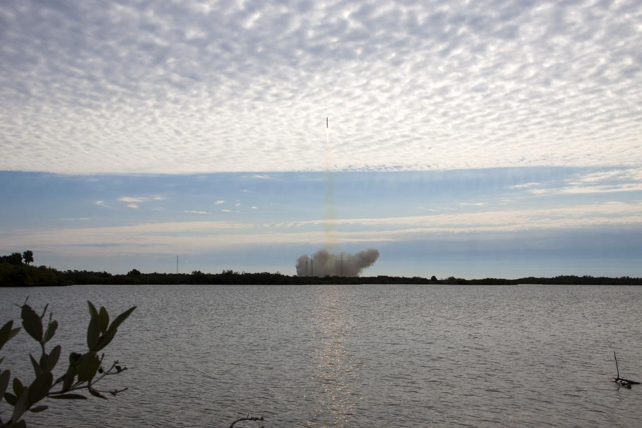 CAPE CANAVERAL, Fla. -- A Space Exploration Technologies, or SpaceX, Falcon 9 rocket pierces the dimpled cloud layer over Space Launch Complex 40 on Cape Canaveral Air Force Station in Florida, carrying a Dragon capsule filled with cargo to orbit. Launch was at 10:10 a.m. EST.  The SpaceX Dragon capsule is making its third trip to the International Space Station, following a demonstration flight in May 2012 and the first resupply mission in October 2012. The mission is the second of 12 SpaceX flights contracted by NASA to resupply the orbiting laboratory. For more information, visit http:__www.nasa.gov_mission_pages_station_structure_launch_spacex2-feature.html.  Photo credit: NASA_Jim Grossmann