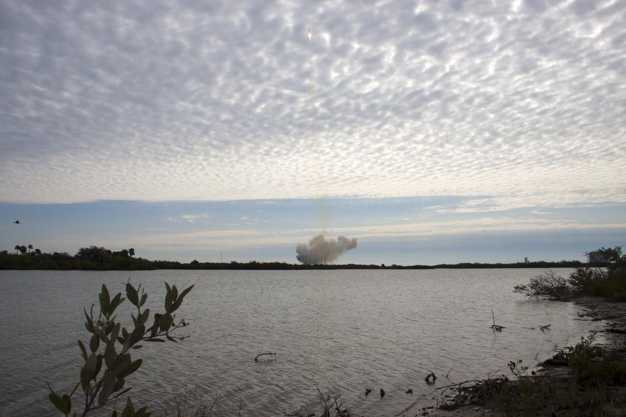 CAPE CANAVERAL, Fla. -- A plume of exhaust and smoke engulfing Space Launch Complex 40 on Cape Canaveral Air Force Station in Florida is evidence that the Space Exploration Technologies, or SpaceX, Falcon 9 rocket, carrying a Dragon capsule filled with cargo, is on its way to orbit.  Launch was at 10:10 a.m. EST.  The SpaceX Dragon capsule is making its third trip to the International Space Station, following a demonstration flight in May 2012 and the first resupply mission in October 2012. The mission is the second of 12 SpaceX flights contracted by NASA to resupply the orbiting laboratory. For more information, visit http:__www.nasa.gov_mission_pages_station_structure_launch_spacex2-feature.html.  Photo credit: NASA_Jim Grossmann