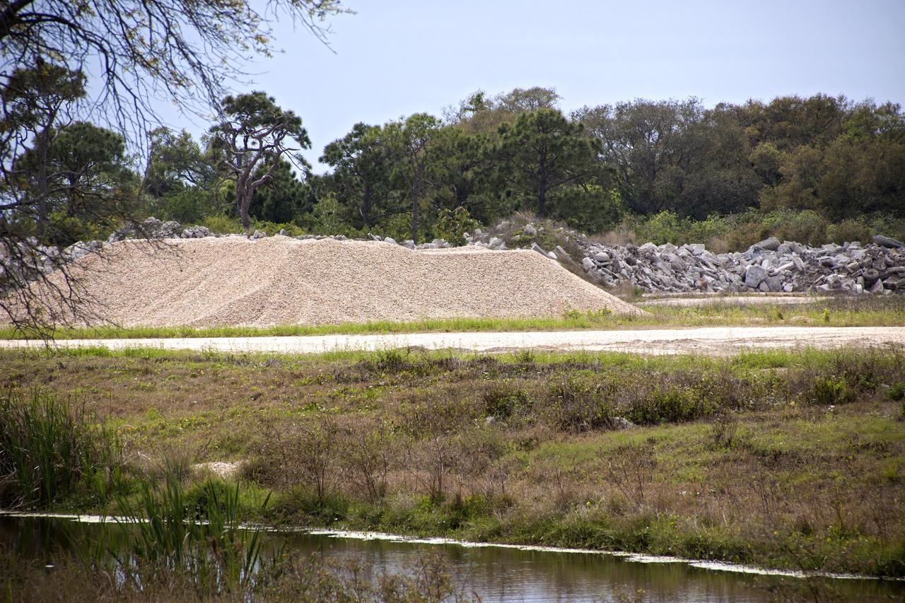 CAPE CANAVERAL, Fla. -- At NASA’s Kennedy Space Center in Florida, workers from Canaveral Construction in Mims, Fla., removed the Alabama river rock from sections of the crawlerway near Launch Pad 39B and transported it to the landfill.   The crawlerway is being upgraded to improve the foundation and prepare it to support the weight of NASA’s Space Launch System, or SLS, and mobile launcher on the crawler-transporter during rollout. Workers are removing the original Alabama river rock and restoring the layer of lime rock below to its original depth. Then new river rock will be added on top. The Ground Systems Development and Operations, or GSDO, Program office at Kennedy is leading the center’s transformation to safely handle a variety of rockets and spacecraft. For more information about GSDO, visit: http:__go.nasa.gov_groundsystems.  Photo credit: NASA_Jim Grossmann
