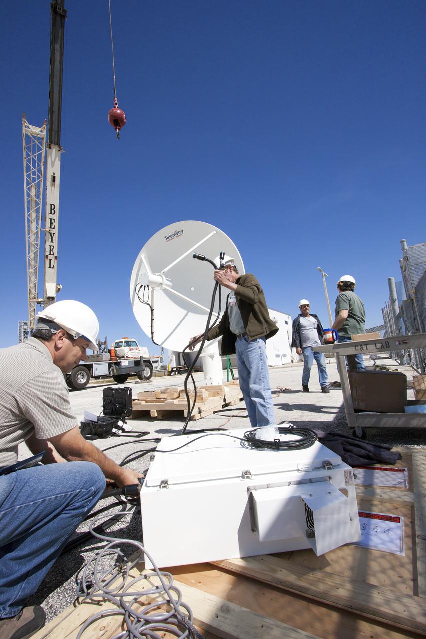CAPE CANAVERAL, Fla. – Workers prepare to install a new parabolic telemetry antenna and tracker camera via crane to the roof of the Launch Control Center, or LCC, in Launch Complex 39 at NASA's Kennedy Space Center in Florida. This antenna and camera system is the first of three that will be installed on the LCC roof for the Radio Frequency and Telemetry Station RFTS, which will be used to monitor radio frequency communications from a launch vehicle at Launch Pad 39A or B as well as provide radio frequency relay for a launch vehicle in the Vehicle Assembly Building. The RFTS replaces the shuttle-era communications and tracking labs at Kennedy. The modern RFTS checkout station is designed to primarily support NASA's Space Launch System, or SLS, and Orion spacecraft, but can support multi-user radio frequency tests as the space center transitions to support a variety of rockets and spacecraft.       For more information on the modernization efforts at Kennedy, visit the Ground Systems Development and Operations, or GSDO, website at http:__go.nasa.gov_groundsystems. Photo credit: NASA_Jim Grossmann
