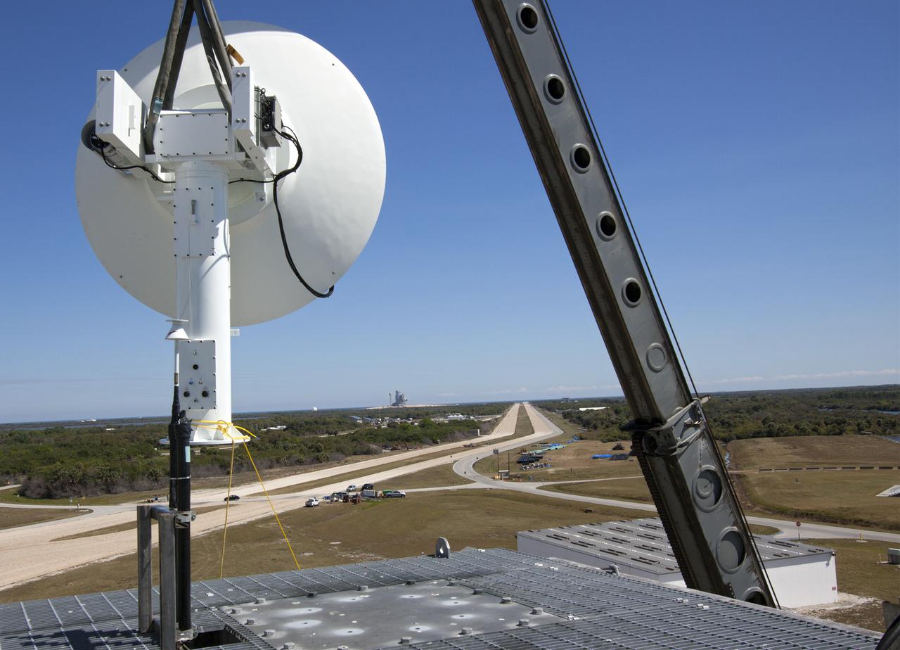 CAPE CANAVERAL, Fla. – A crane lifts a new parabolic telemetry antenna and tracker camera to the roof of the Launch Control Center, or LCC, in Launch Complex 39 at NASA's Kennedy Space Center in Florida. This antenna and camera system is the first of three that will be installed on the LCC roof for the Radio Frequency and Telemetry Station RFTS, which will be used to monitor radio frequency communications from a launch vehicle at Launch Pad 39A or B as well as provide radio frequency relay for a launch vehicle in the Vehicle Assembly Building. The RFTS replaces the shuttle-era communications and tracking labs at Kennedy. The modern RFTS checkout station is designed to primarily support NASA's Space Launch System, or SLS, and Orion spacecraft, but can support multi-user radio frequency tests as the space center transitions to support a variety of rockets and spacecraft.  For more information on the modernization efforts at Kennedy, visit the Ground Systems Development and Operations, or GSDO, website at http:__go.nasa.gov_groundsystems. Photo credit: NASA_Jim Grossmann
