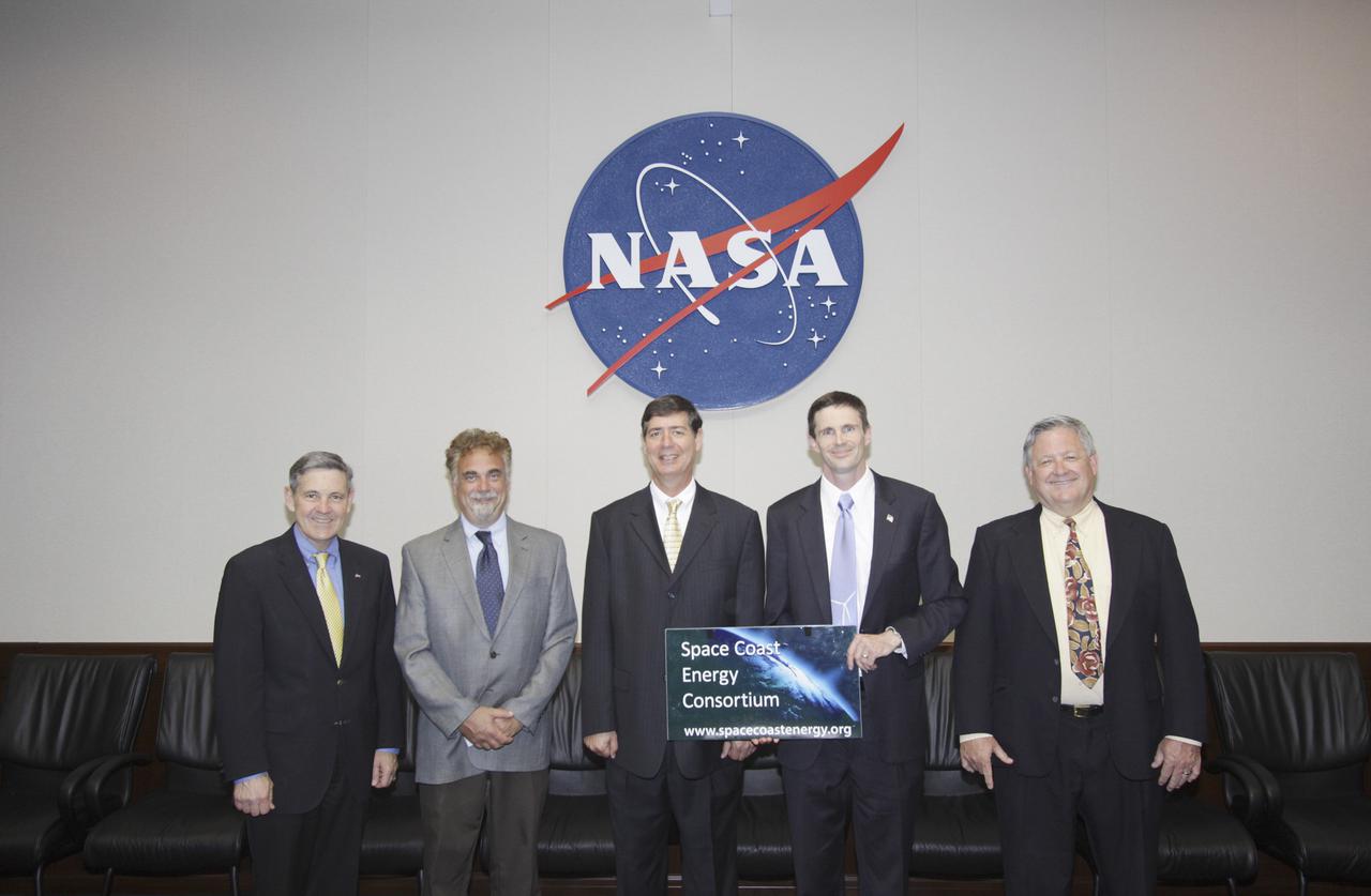 CAPE CANAVERAL, Fla. -- Kennedy Space Center Director Bob Cabana joins representatives of the Space Coast Energy Consortium after signing a Space Act Agreement between the two organizations. From the left are, Cabana, Scott Lewit, chairman of the SCEC’s board of directors, Bennett Boucher, SCEC board member, Mike Aller, SCEC executive director, and Rodger Rees, SCEC chief financial officer.   The Cape Canaveral-based energy consortium is an industry-led nonprofit association created to identify and create innovative energy opportunities for the Space Coast and Florida. The organization was formed by community and industry leaders to assist with the post-space shuttle transition by building networks among local businesses with resources across the country. Photo credit: NASA_Jim Grossmann