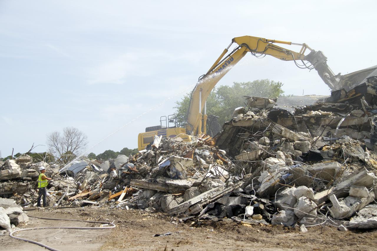 CAPE CANAVERAL, Fla. -- At NASA’s Kennedy Space Center in Florida, demolition is underway on the Base Operations Building, or BOB, in the Industrial Area. Water is being sprayed in the area to control the dust created during the demolition process. The two-story BOB was constructed in 1965 as office space for workers. Kennedy is demolishing some of the older facilities due to their age and to reduce maintenance and repair costs. Photo credit: NASA_ Cory Huston