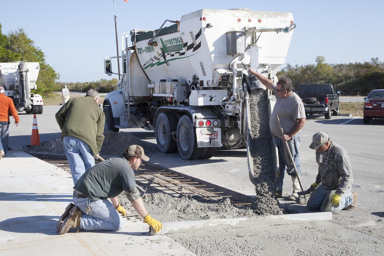 CAPE CANAVERAL, Fla. – Workers pour a concrete mix that utilizes spent material from sandblasting projects at NASA's Kennedy Space Center in Florida. The experimental formula is being tested at the Propellants North facility at Kennedy and will undergo structural and other evaluations as part of a pilot project. Spent blast media, or SBM, makes up much of the waste deposited at the center's landfill and engineers are trying to develop ways to put the debris to use in other ways instead. Photo credit: NASA_Kim Shiflett