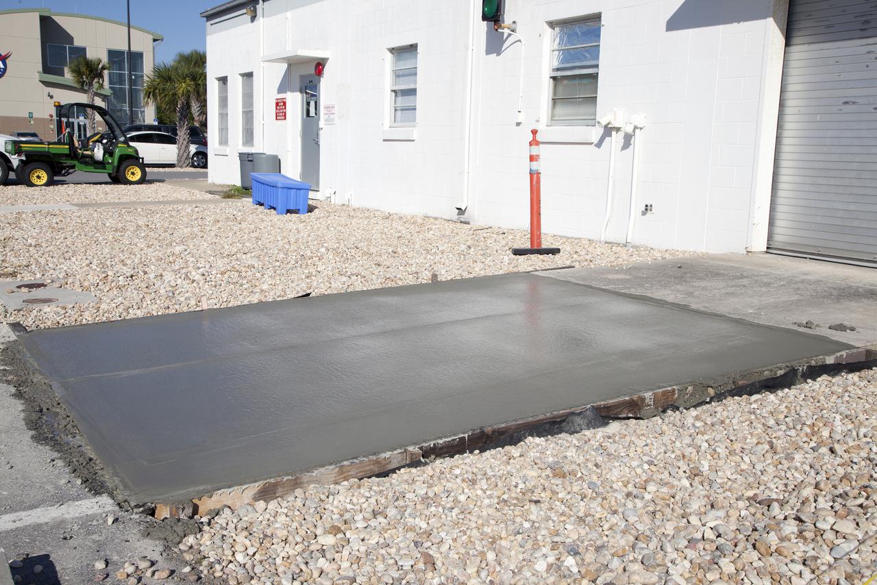 CAPE CANAVERAL, Fla. – A driveway made from a concrete mix that utilizes spent material from sandblasting projects at NASA's Kennedy Space Center in Florida. The experimental formula is being tested at the Propellants North facility at Kennedy and will undergo structural and other evaluations as part of a pilot project. Spent blast media, or SBM, makes up much of the waste deposited at the center's landfill and engineers are trying to develop ways to put the debris to use in other ways instead. Photo credit: NASA_Kim Shiflett