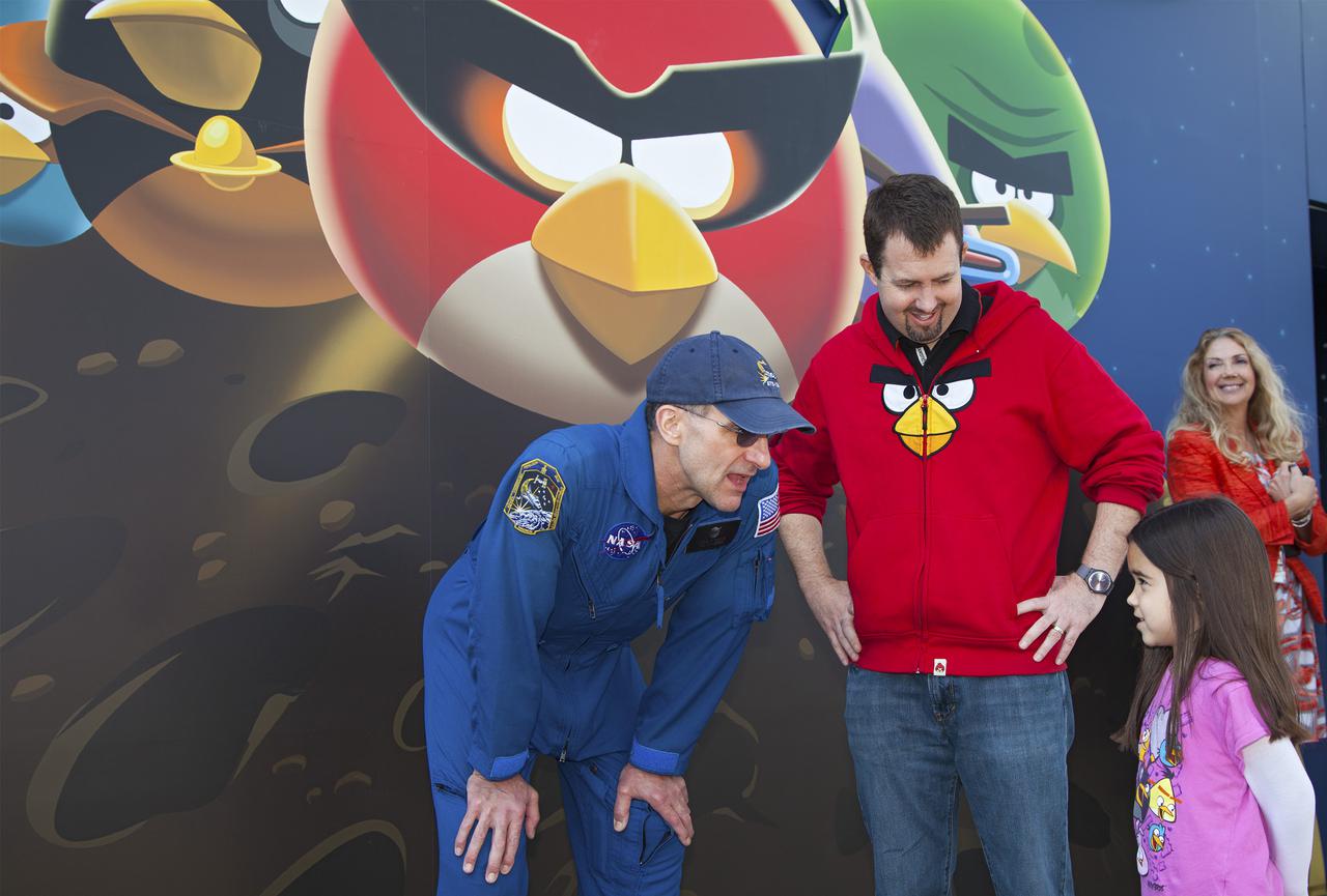 CAPE CANAVERAL, Fla. -- At NASA’s Kennedy Space Center Visitor Complex in Florida, NASA astronaut Don Pettit and Rovio Entertainment Director Dan Mitchell greet visitors near the entrance to the new Angry Birds Space Encounter during the grand opening ceremony. Pettit spent a total of 12 months during two separate missions aboard the International Space Station and introduced Angry Birds Space while floating in zero gravity.  Finland-based Rovio Entertainment, the creator of the Angry Birds Space game, partnered with Kennedy Space Center to bring the beloved characters to life. It is the first Angry Birds interactive exhibit in the United States designed for people of all ages. The 4,485-square-foot facility hosts the space adventures of the Angry Birds as they travel into an intergalactic wormhole, come face-to-face with Space Pigs and discover heroic superpowers. Six interactive stations are designed to encourage children in science, technology, engineering and mathematics fields of study. Photo credit: NASA_Kim Shiflett