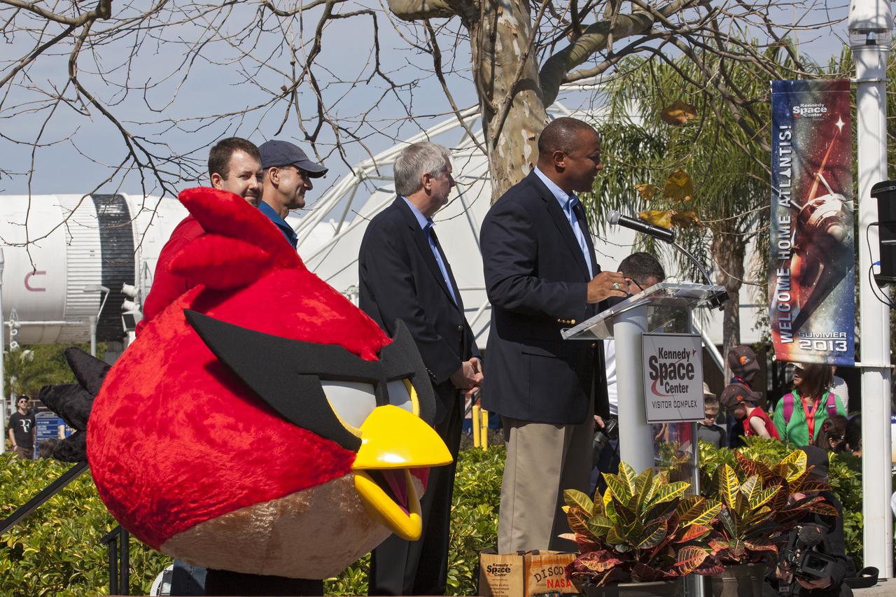 CAPE CANAVERAL, Fla. -- At NASA’s Kennedy Space Center Visitor Complex in Florida, Kelvin Manning, associate deputy director of Kennedy Space Center, speaks to visitors during the grand opening of the new Angry Birds Space Encounter. Standing behind Manning, from left are Dan Mitchell, director of location-based entertainment for Rovio Entertainment NASA astronaut Don Pettit and Bill Moore, chief operating officer with the KSC visitor complex. Also in the photo is Red Bird, one of the Angry Bird Space characters.  Finland-based Rovio Entertainment, the creator of the Angry Birds Space game, partnered with Kennedy Space Center to bring the beloved characters to life. It is the first Angry Birds interactive exhibit in the United States designed for people of all ages. The 4,485-square-foot facility hosts the space adventures of the Angry Birds as they travel into an intergalactic wormhole, come face-to-face with Space Pigs and discover heroic superpowers. Six interactive stations are designed to encourage children in science, technology, engineering and mathematics fields of study. Photo credit: NASA_Kim Shiflett
