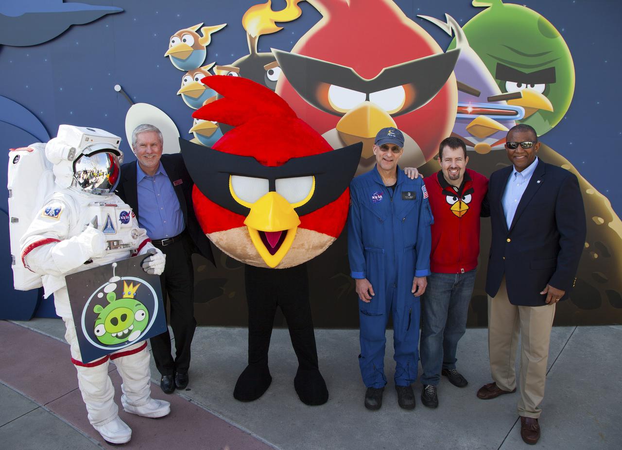 CAPE CANAVERAL, Fla. -- At NASA’s Kennedy Space Center Visitor Complex in Florida, the new Angry Birds Space Encounter was opened to visitors during a grand opening celebration. Helping to open the new attraction, from left are Spaceperson Bill Moore, chief operating officer of the KSC visitor complex Red Bird, one of the Angry Bird characters NASA astronaut Don Pettit Dan Mitchell, director of location-based entertainment for Rovio Entertainment and Kelvin Manning, associate deputy director of Kennedy Space Center.    Finland-based Rovio Entertainment, the creator of the Angry Birds Space game, partnered with Kennedy Space Center to bring the beloved characters to life. It is the first Angry Birds interactive exhibit in the United States designed for people of all ages. The 4,485-square-foot facility hosts the space adventures of the Angry Birds as they travel into an intergalactic wormhole, come face-to-face with Space Pigs and discover heroic superpowers. Six interactive stations are designed to encourage children in science, technology, engineering and mathematics fields of study. Photo credit: NASA_Kim Shiflett