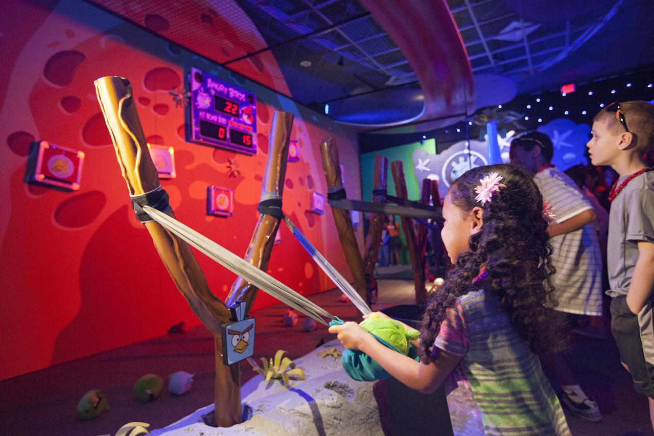 CAPE CANAVERAL, Fla. -- At NASA’s Kennedy Space Center Visitor Complex in Florida, children try out some of the interactive exhibits inside the new Angry Birds Space Encounter after the grand opening ceremony for the new attraction.     Finland-based Rovio Entertainment, the creator of the Angry Birds Space game, partnered with Kennedy Space Center to bring the beloved characters to life. It is the first Angry Birds interactive exhibit in the United States designed for people of all ages. The 4,485-square-foot facility hosts the space adventures of the Angry Birds as they travel into an intergalactic wormhole, come face-to-face with Space Pigs and discover heroic superpowers. Six interactive stations are designed to encourage children in science, technology, engineering and mathematics fields of study. Photo credit: NASA_Kim Shiflett