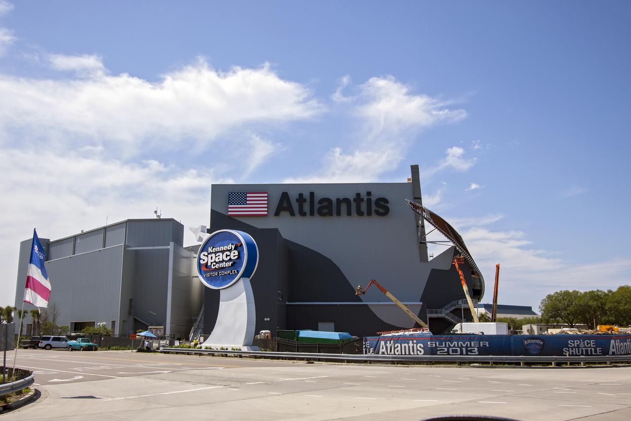 CAPE CANAVERAL, Fla. -- The Kennedy Space Center Visitor Complex has added the name 'Atlantis' and American flag to the exterior of the 'Space Shuttle Atlantis' exhibit scheduled to open June 29, 2013. Last November, the space shuttle Atlantis made its historic final journey to its new home, traveling 10 miles from the Kennedy Space Center's Vehicle Assembly Building to the spaceport's visitor complex. The new $100 million Atlantis facility will be a 90,000-square-foot, interactive exhibit that tells the story of the 30-year Space Shuttle Program and highlights the future of space exploration. Photo credit: NASA_Jim Grossmann