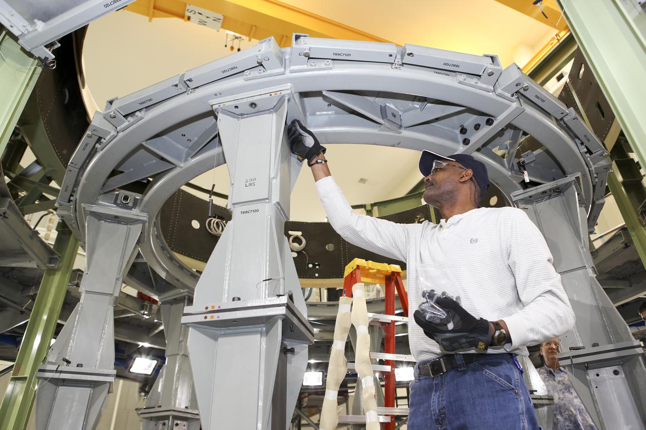 CAPE CANAVERAL, Fla. – Inside the Operations and Checkout Building high bay at NASA’s Kennedy Space Center in Florida, a technician prepares a processing tool for lifting out of an Orion service module work stand. Work continues to prepare for Exploration Flight Test 1, or EFT-1. Orion is the exploration spacecraft designed to carry crews to space beyond low Earth orbit. It will provide emergency abort capability, sustain the crew during the space travel and provide safe re-entry from deep space return velocities. Orion’s first unpiloted test flight is scheduled to launch in 2014 atop a United Launch Alliance Delta IV heavy rocket. A second uncrewed flight test is scheduled for 2017 on the Space Launch System rocket. For more information, visit http:__www.nasa.gov_orion. Photo credit: NASA_Charisse Nahser
