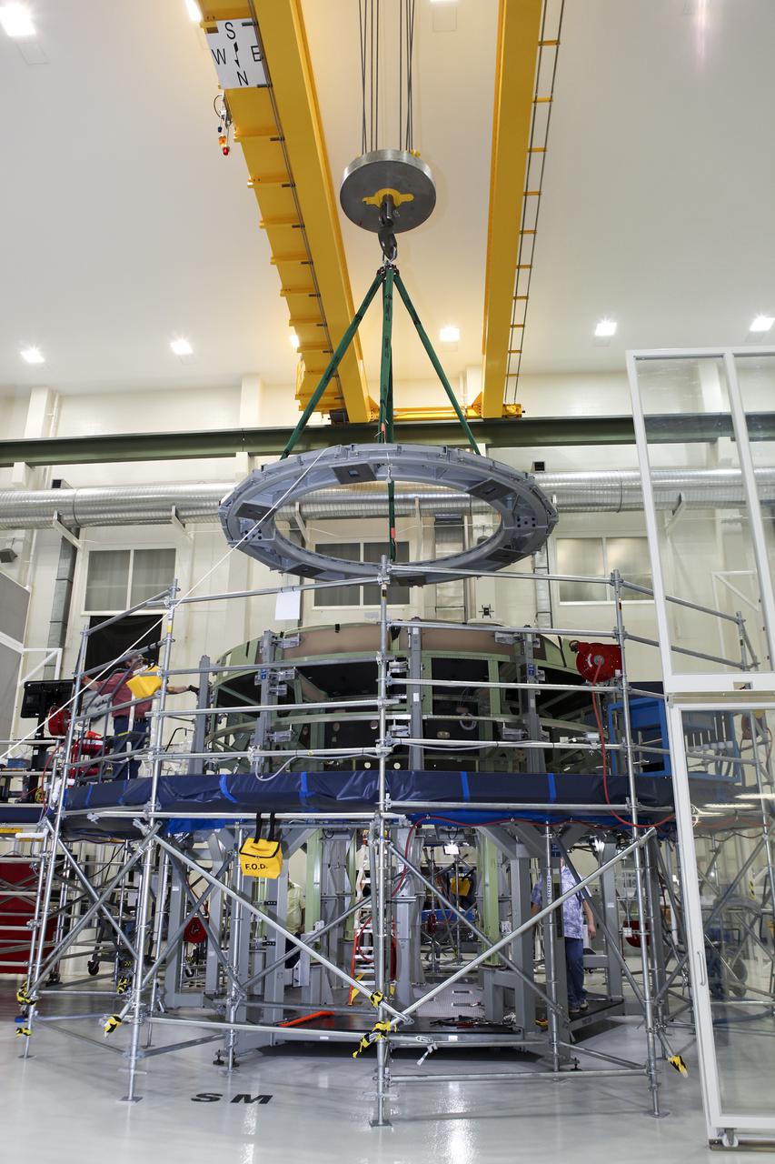 CAPE CANAVERAL, Fla. – Inside the Operations and Checkout Building high bay at NASA’s Kennedy Space Center in Florida, a processing tool is lifted out of an Orion service module work stand. Work continues to prepare for Exploration Flight Test 1, or EFT-1. Orion is the exploration spacecraft designed to carry crews to space beyond low Earth orbit. It will provide emergency abort capability, sustain the crew during the space travel and provide safe re-entry from deep space return velocities. Orion’s first unpiloted test flight is scheduled to launch in 2014 atop a United Launch Alliance Delta IV heavy rocket. A second uncrewed flight test is scheduled for 2017 on the Space Launch System rocket. For more information, visit http:__www.nasa.gov_orion. Photo credit: NASA_Charisse Nahser