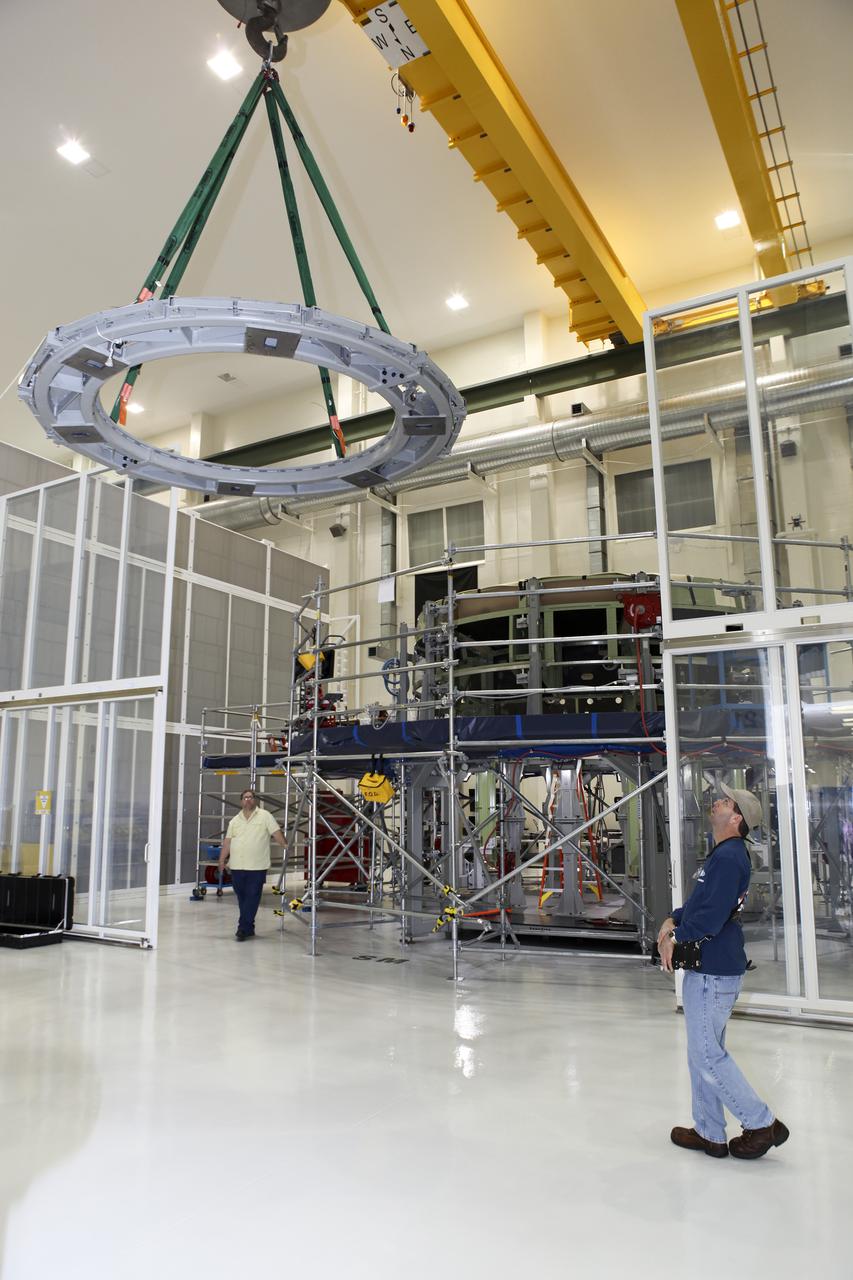 CAPE CANAVERAL, Fla. – Inside the Operations and Checkout Building high bay at NASA’s Kennedy Space Center in Florida, technicians monitor the progress as a processing tool is lifted away from an Orion service module work stand. Work continues to prepare for Exploration Flight Test 1, or EFT-1. Orion is the exploration spacecraft designed to carry crews to space beyond low Earth orbit. It will provide emergency abort capability, sustain the crew during the space travel and provide safe re-entry from deep space return velocities. Orion’s first unpiloted test flight is scheduled to launch in 2014 atop a United Launch Alliance Delta IV heavy rocket. A second uncrewed flight test is scheduled for 2017 on the Space Launch System rocket. For more information, visit http:__www.nasa.gov_orion. Photo credit: NASA_Charisse Nahser