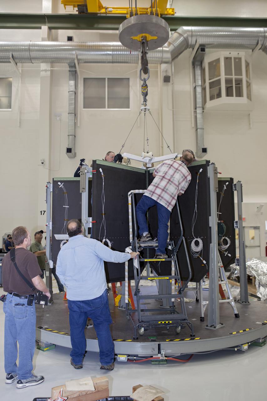 CAPE CANAVERAL, Fla. – Inside the Operations and Checkout Building high bay at NASA’s Kennedy Space Center in Florida, technicians attach a crane to the shear web assembly, or inner core, that will be inserted into the Orion service module. Orion is being prepared for Exploration Flight Test 1, or EFT-1. Orion is the exploration spacecraft designed to carry crews to space beyond low Earth orbit. It will provide emergency abort capability, sustain the crew during the space travel and provide safe re-entry from deep space return velocities. Orion’s first unpiloted test flight is scheduled to launch in 2014 atop a United Launch Alliance Delta IV heavy rocket. A second uncrewed flight test is scheduled for 2017 on the Space Launch System rocket. For more information, visit http:__www.nasa.gov_orion. Photo credit: NASA_Dimitri Gerondidakis
