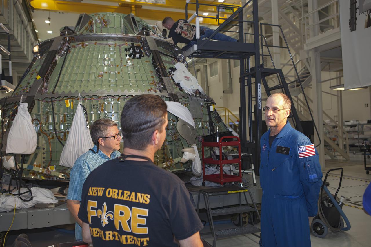 CAPE CANAVERAL, Fla. – Inside the Operations and Checkout Building high bay at NASA’s Kennedy Space Center in Florida, astronaut Don Pettit speaks with technicians about the work they are doing to process the Orion spacecraft. Orion is being prepared for Exploration Flight Test 1, or EFT-1. Orion is the exploration spacecraft designed to carry crews to space beyond low Earth orbit. It will provide emergency abort capability, sustain the crew during the space travel and provide safe re-entry from deep space return velocities. Orion’s first unpiloted test flight is scheduled to launch in 2014 atop a United Launch Alliance Delta IV heavy rocket. A second uncrewed flight test is scheduled for 2017 on the Space Launch System rocket. For more information, visit http:__www.nasa.gov_orion. Photo credit: NASA_Dimitri Gerondidakis