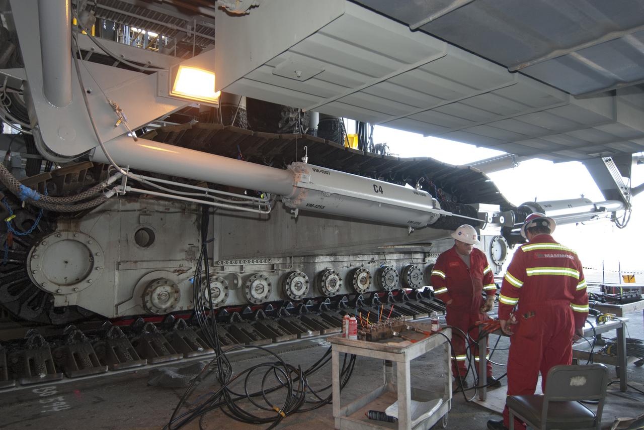 CAPE CANAVERAL, Fla. -- Technicians in the Vehicle Assembly Building at NASA’s Kennedy Space Center in Florida, prepare crawler-transporter 2, or CT-2, for removal of the roller bearing assemblies. After inspections, new assemblies will be installed. The Ground Systems Development and Operations Program office at Kennedy is overseeing the upgrades to CT-2 so that it can carry NASA’s Space Launch System heavy-lift rocket and new Orion spacecraft to the launch pad. For more than 45 years the crawler-transporters were used to transport the mobile launcher platform and the Apollo-Saturn V rockets and, later, space shuttles to Launch Pads 39A and B. For more information: http:__www.nasa.gov_exploration_systems_ground_crawler-transporter_bearings.html Photo credit: NASA_Tim Jacobs
