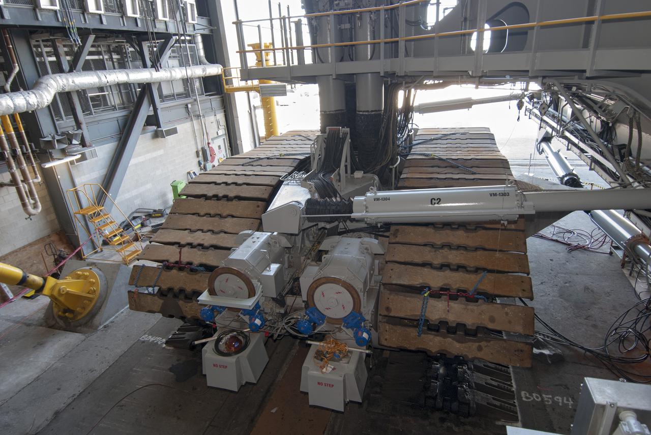CAPE CANAVERAL, Fla. -- In the Vehicle Assembly Building at NASA’s Kennedy Space Center in Florida, crawler-transporter 2, or CT-2, has been jacked four feet off the floor to facilitate removal of the roller bearing assemblies. After inspections, new assemblies will be installed. The Ground Systems Development and Operations Program office at Kennedy is overseeing the upgrades to CT-2 so that it can carry NASA’s Space Launch System heavy-lift rocket and new Orion spacecraft to the launch pad. For more than 45 years the crawler-transporters were used to transport the mobile launcher platform and the Apollo-Saturn V rockets and, later, space shuttles to Launch Pads 39A and B. For more information: http:__www.nasa.gov_exploration_systems_ground_crawler-transporter_bearings.html Photo credit: NASA_Tim Jacobs