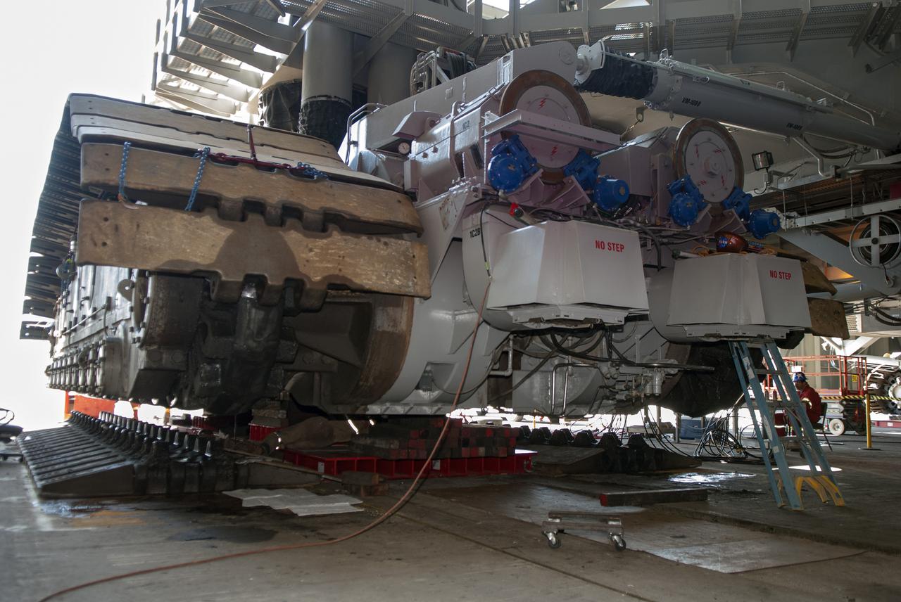 CAPE CANAVERAL, Fla. -- In the Vehicle Assembly Building at NASA’s Kennedy Space Center in Florida, crawler-transporter 2, or CT-2, has been jacked four feet off the floor to facilitate removal of the roller bearing assemblies. After inspections, new assemblies will be installed. The Ground Systems Development and Operations Program office at Kennedy is overseeing the upgrades to CT-2 so that it can carry NASA’s Space Launch System heavy-lift rocket and new Orion spacecraft to the launch pad. For more than 45 years the crawler-transporters were used to transport the mobile launcher platform and the Apollo-Saturn V rockets and, later, space shuttles to Launch Pads 39A and B. For more information: http:__www.nasa.gov_exploration_systems_ground_crawler-transporter_bearings.html Photo credit: NASA_Tim Jacobs