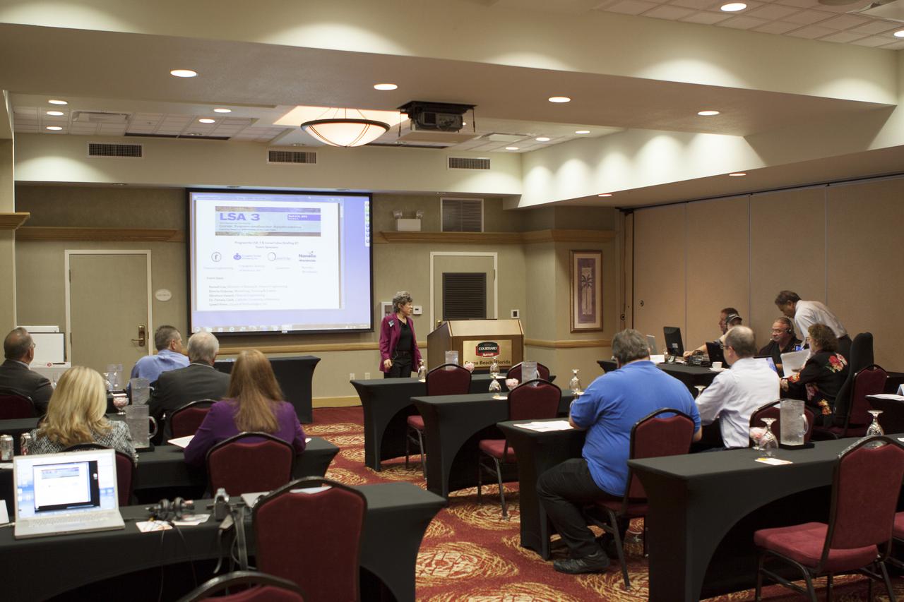 CAPE CANAVERAL, Fla. – At the Courtyard by Marriott hotel in Cocoa Beach, Fla., Bonnie Dubrow, business development manager with Flexure Engineering, welcomes participants in the room and those participating online to the Third International Workshop on Lunar Superconductor Applications. The workshop included presentations from several engineers and researchers at Kennedy Space Center.  The three-day workshop included presentations from speakers throughout the country and focused on Lunar in-situ resource utilization, NASA’s Lunar Ice Prospector called RESOLVE, CubeSats, cryogenic storage and many other topics related to lunar exploration. Photo credit: NASA_Jim Grossmann